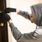 profile-view-man-with-hoodie-trying-pick-lock-house-forcing-his-entry (1) (1)